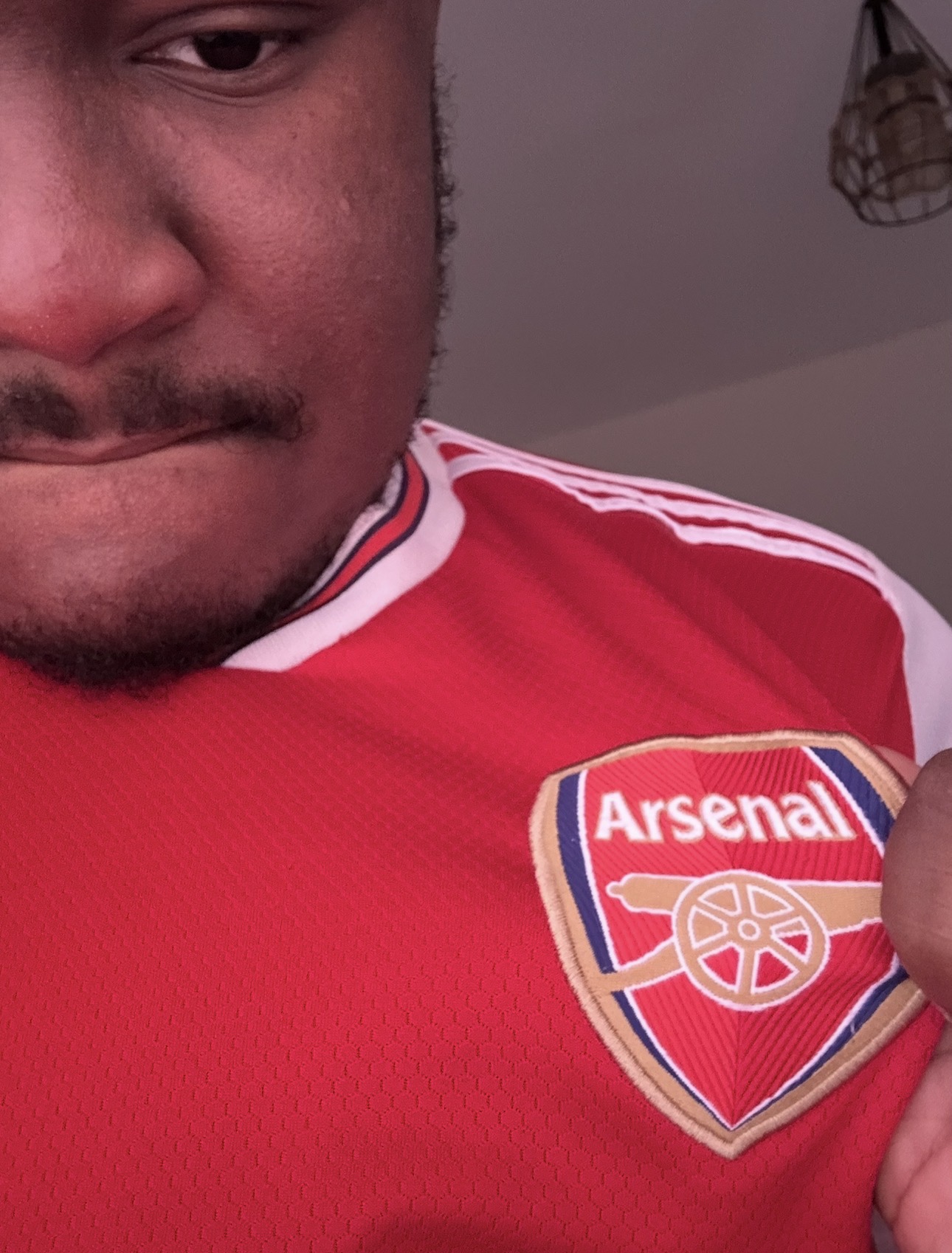 AJ wearing an Arsenal football jersey
